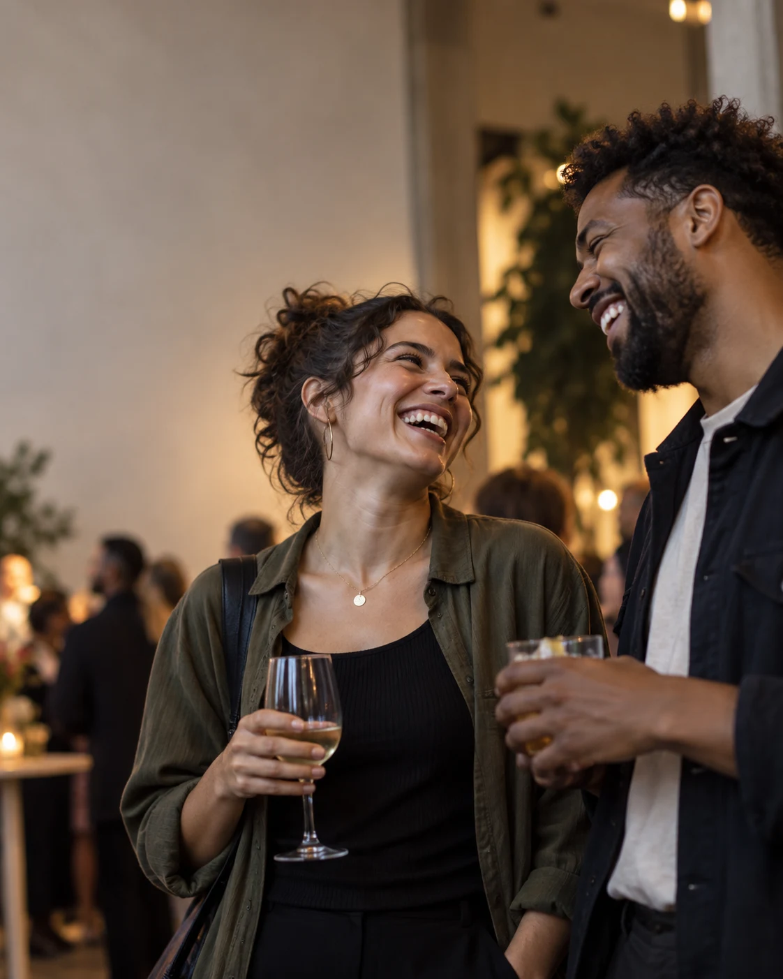 Two people sharing a conversation at an evening gathering