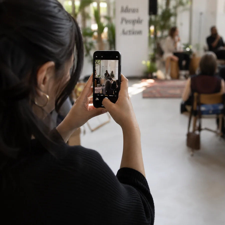 An attendee capturing a moment on her phone