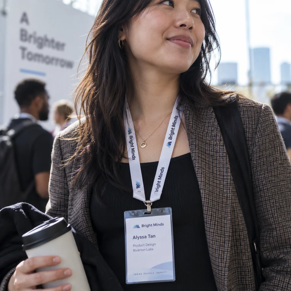 An attendee between conversations at a work event